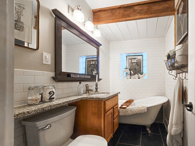 full bath with vanity, toilet, tile walls, and a freestanding bath