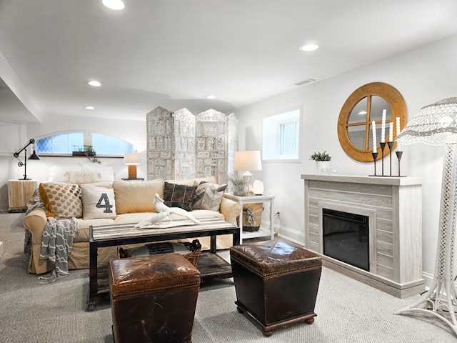 living room with visible vents, baseboards, a premium fireplace, recessed lighting, and carpet flooring