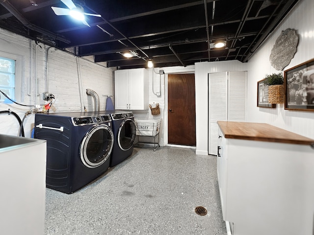 clothes washing area with cabinet space and washing machine and clothes dryer