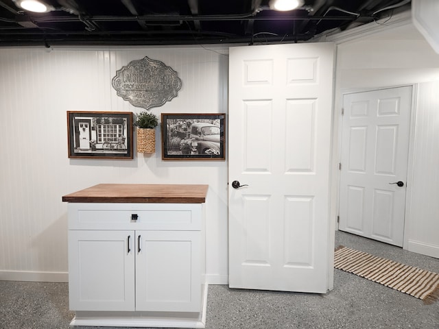 interior space with speckled floor and baseboards