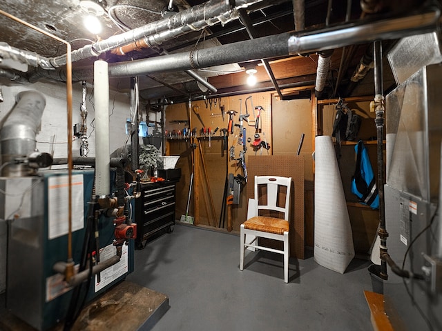 unfinished basement featuring a workshop area and heating unit