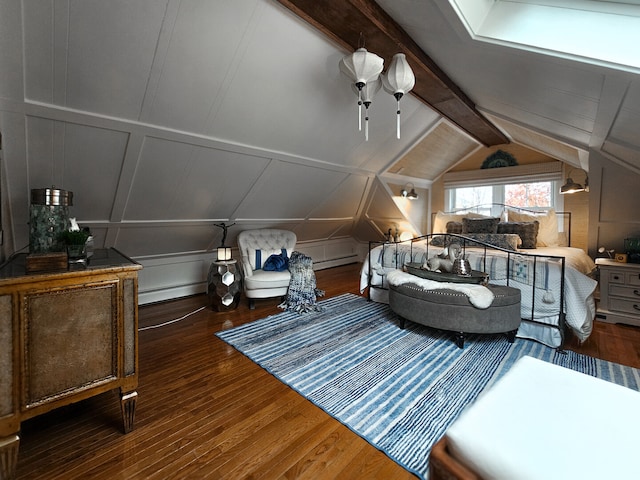 bedroom with lofted ceiling with beams, a decorative wall, wood finished floors, and a baseboard radiator