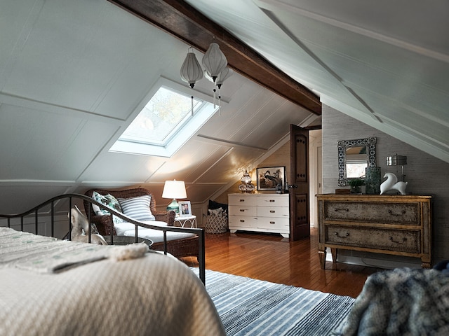 bedroom featuring lofted ceiling with skylight, multiple windows, and wood finished floors