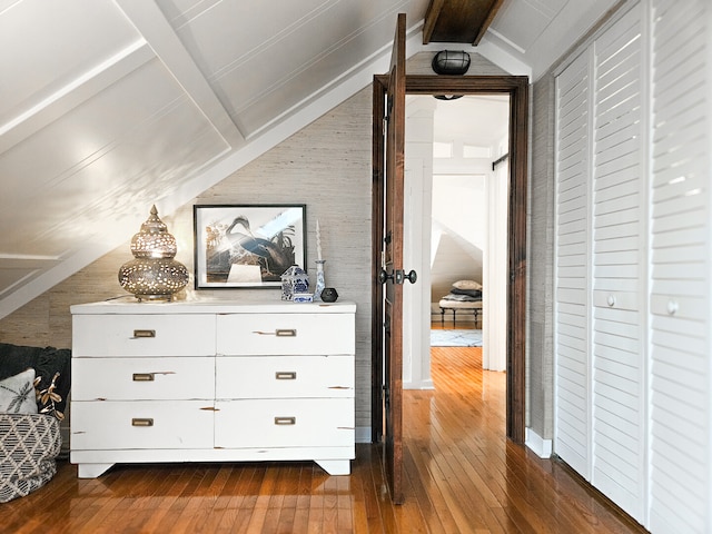 hallway featuring lofted ceiling with beams and dark wood finished floors