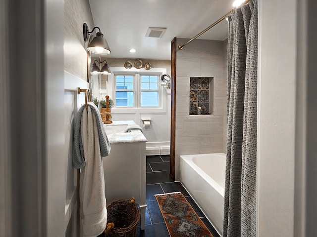 bathroom featuring tile patterned floors, visible vents, vanity, and shower / tub combo