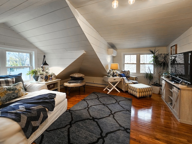 living area with a wall mounted air conditioner, lofted ceiling, a healthy amount of sunlight, and hardwood / wood-style flooring