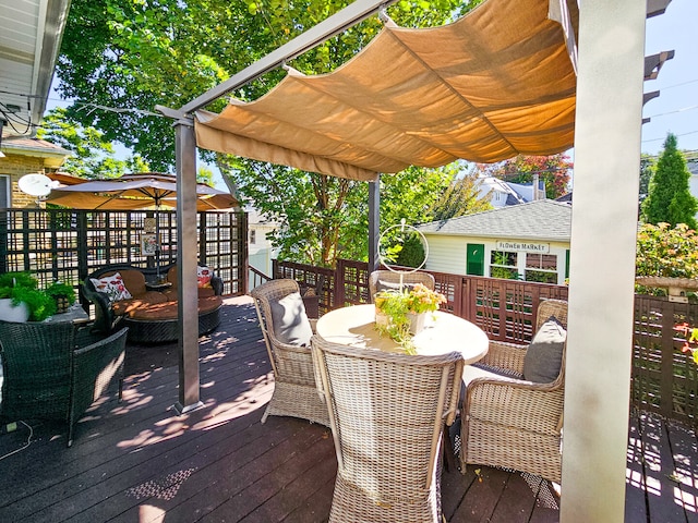 wooden terrace with outdoor dining space and a pergola