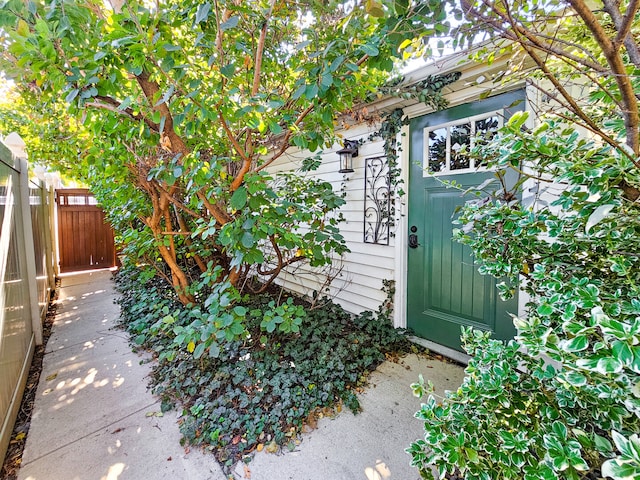 doorway to property featuring fence