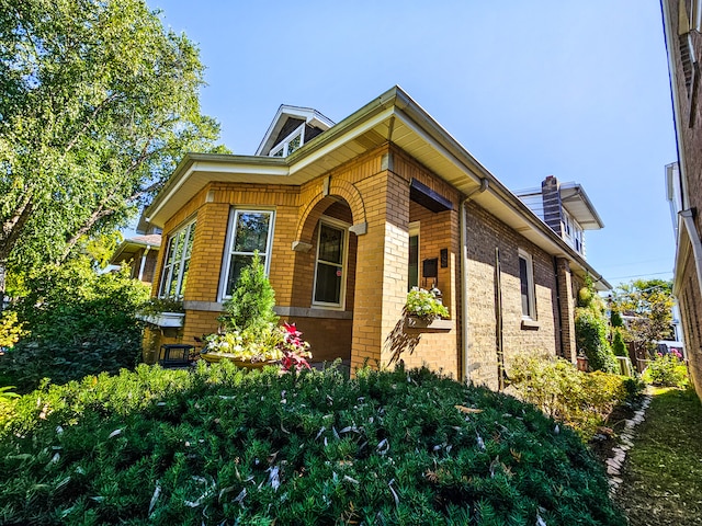 view of property exterior featuring brick siding