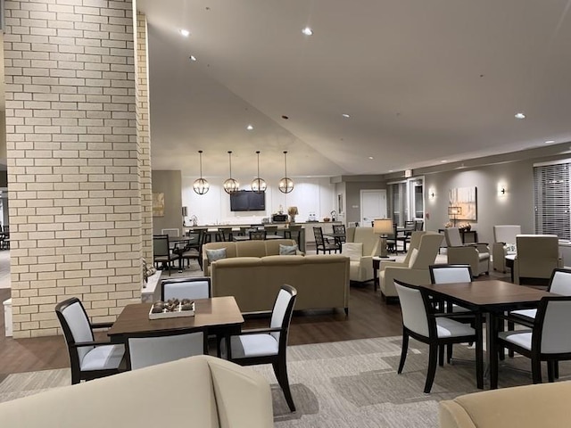 dining area featuring recessed lighting, brick wall, and light wood-style floors