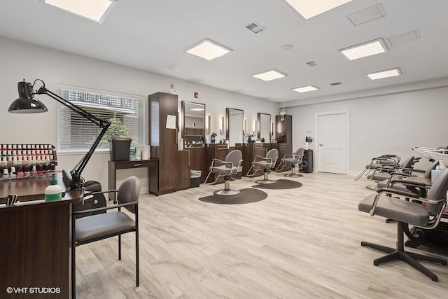 exercise room with visible vents and light wood-style flooring