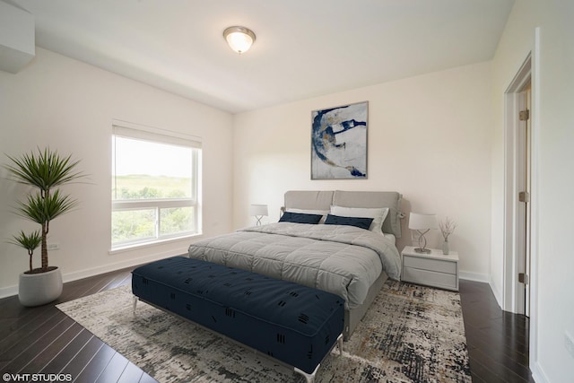 bedroom featuring dark wood-type flooring and baseboards