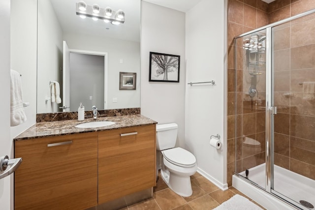 full bathroom featuring tile patterned flooring, a stall shower, toilet, and vanity