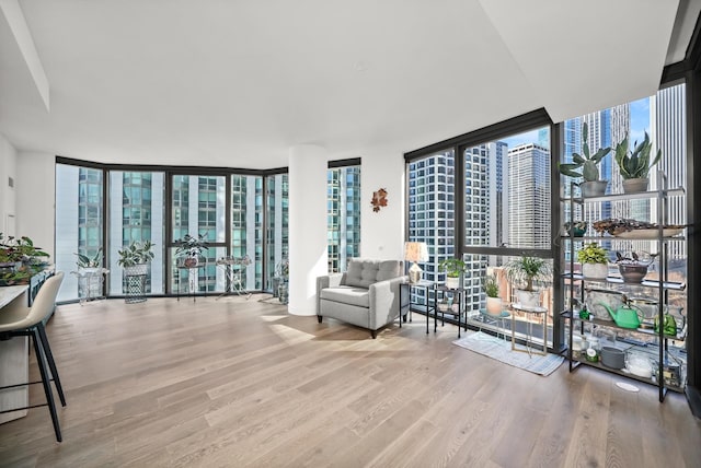 sitting room featuring wood finished floors, a wealth of natural light, and expansive windows