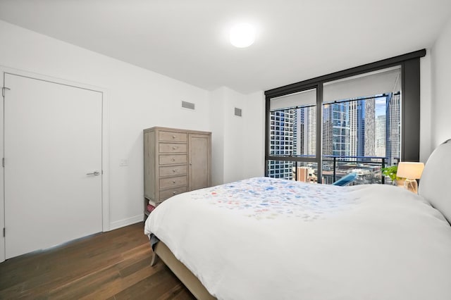 bedroom featuring visible vents and dark wood-style flooring