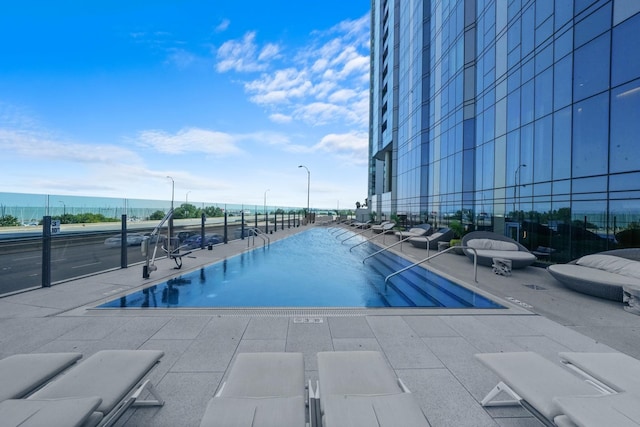 community pool featuring a patio and a water view