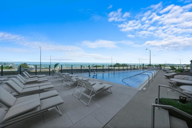 view of pool with a water view