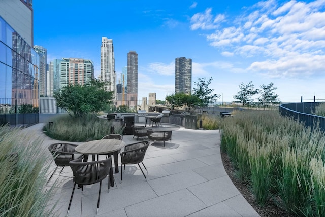 view of patio / terrace with a view of city and outdoor dining area