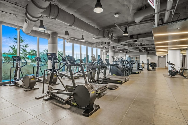 workout area with expansive windows and a view of city