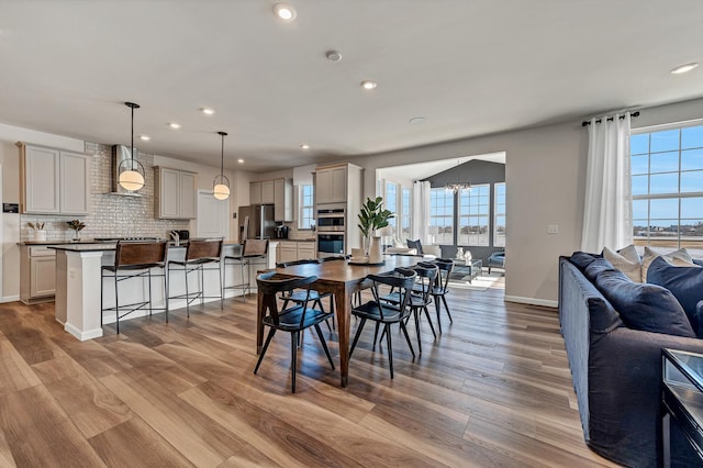 dining area with plenty of natural light, recessed lighting, and wood finished floors