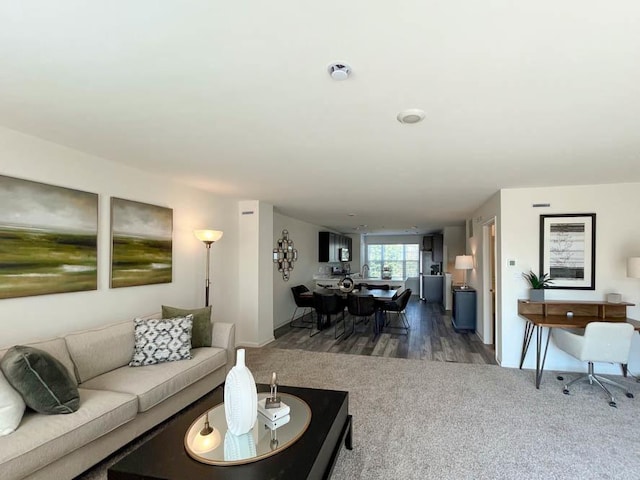 carpeted living room with wood finished floors