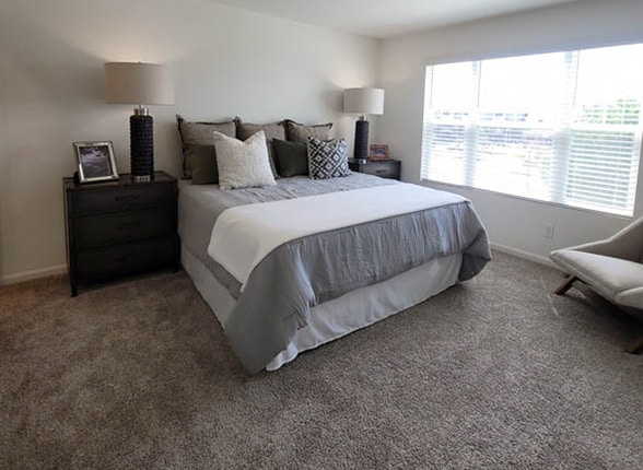 carpeted bedroom featuring baseboards