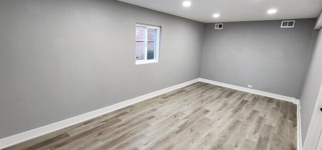 empty room with visible vents, recessed lighting, light wood-type flooring, and baseboards