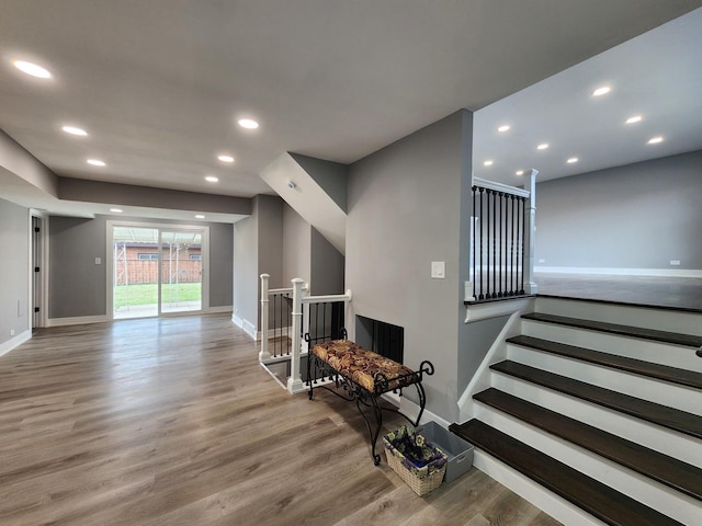 stairs featuring recessed lighting, baseboards, and wood finished floors