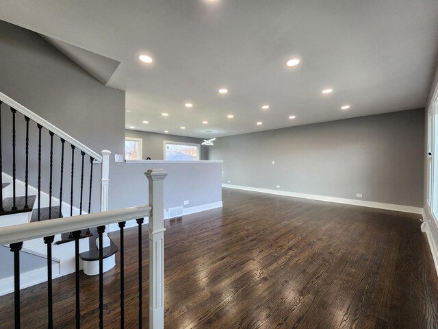 spare room with recessed lighting, baseboards, visible vents, and dark wood-style flooring