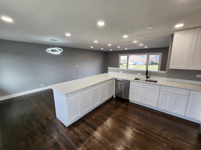 kitchen with light stone counters, a peninsula, a sink, dark wood-type flooring, and stainless steel dishwasher