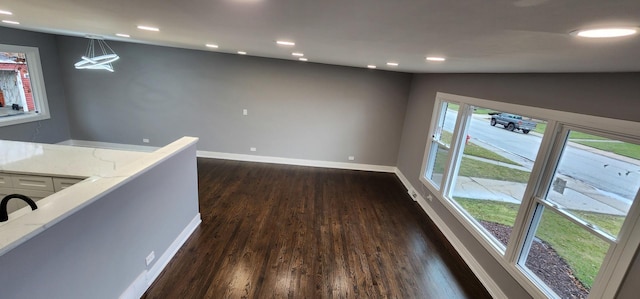 hallway featuring dark wood-style floors, an upstairs landing, recessed lighting, and baseboards