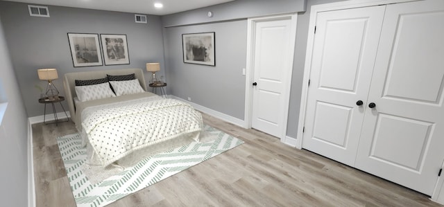 bedroom featuring wood finished floors, visible vents, and baseboards