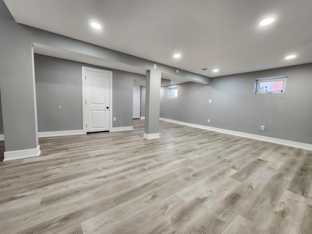 basement featuring light wood finished floors and baseboards