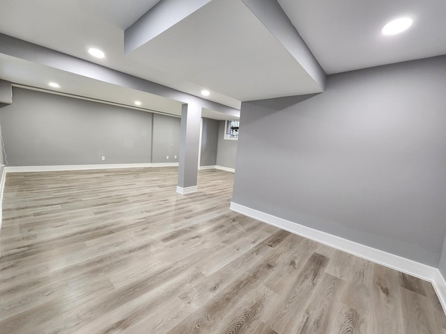 finished basement featuring recessed lighting, baseboards, and light wood finished floors