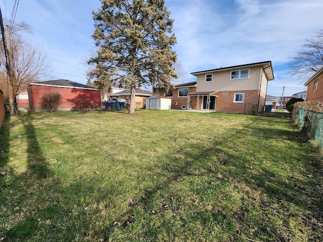 view of yard featuring an outbuilding, a fenced backyard, and a shed