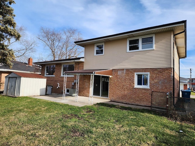 back of property with a patio, a yard, an outdoor structure, a storage shed, and brick siding