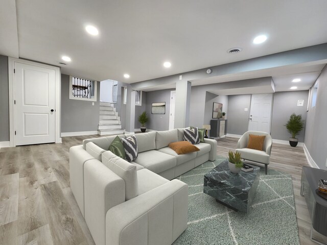 living room featuring visible vents, baseboards, stairway, recessed lighting, and light wood-style flooring