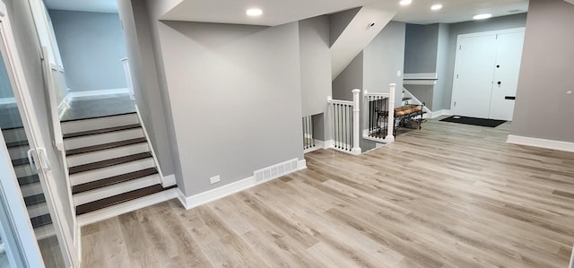 interior space with recessed lighting, wood finished floors, visible vents, and baseboards