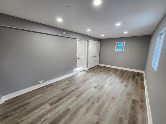 below grade area featuring recessed lighting, baseboards, and wood finished floors