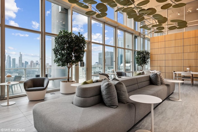 living area with a wall of windows, a view of city, and a wealth of natural light