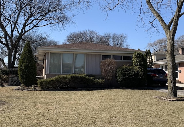 view of side of property featuring a yard