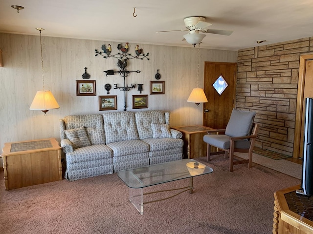 carpeted living room with a ceiling fan and ornamental molding