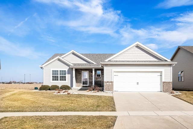 view of front facade with a garage, brick siding, concrete driveway, and a front lawn