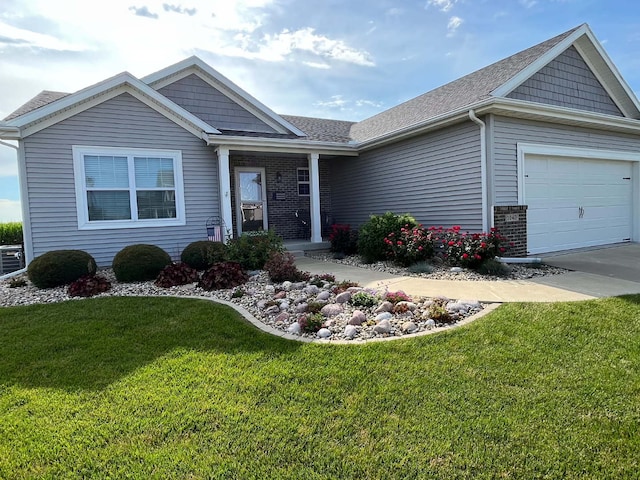 view of front facade with a front lawn, roof with shingles, concrete driveway, a garage, and brick siding