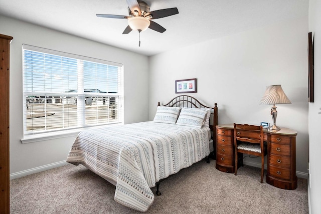 bedroom featuring baseboards, a ceiling fan, and carpet flooring