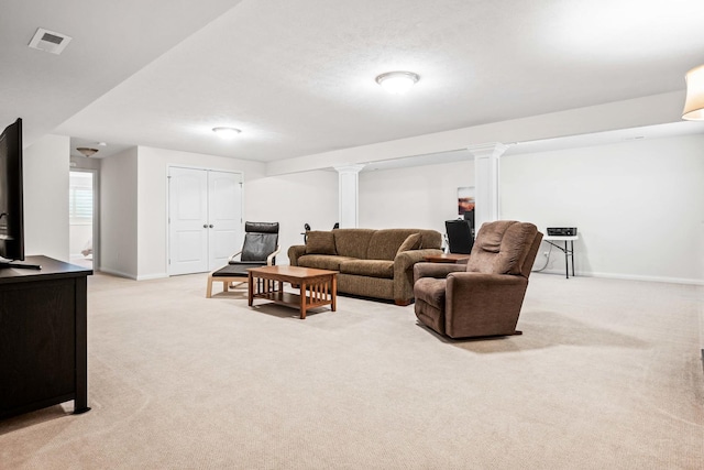 living room featuring light colored carpet, visible vents, ornate columns, and baseboards