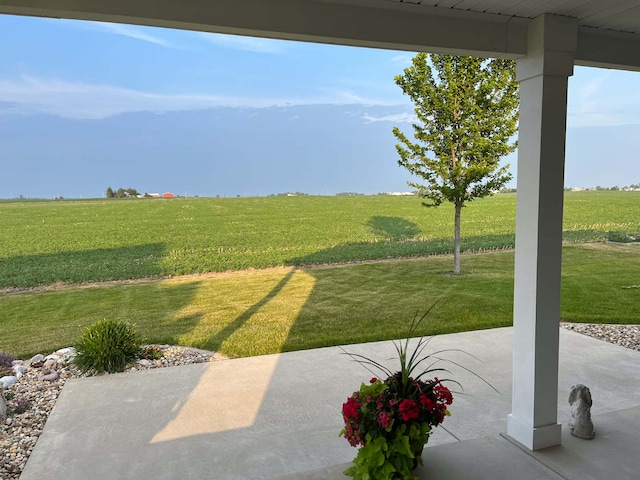 view of yard featuring a patio and a rural view