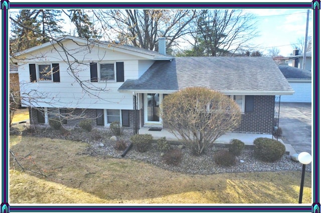 view of front of house with brick siding, a chimney, and a shingled roof