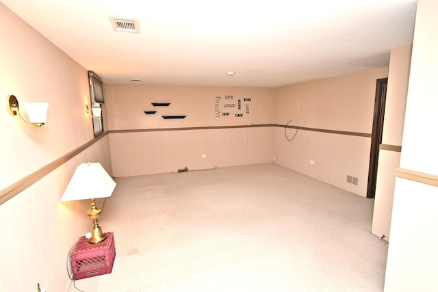 basement featuring stairs, carpet, and visible vents