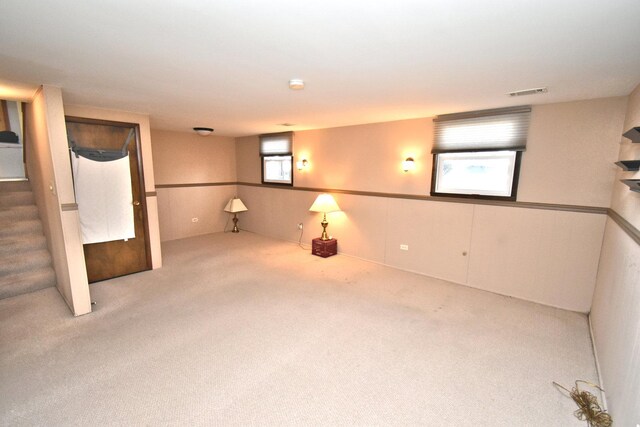 carpeted spare room featuring visible vents